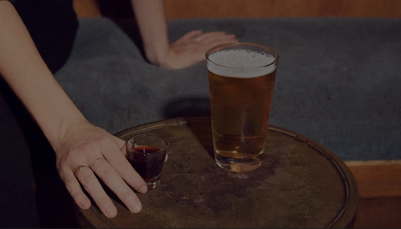 Shot glass and beer on a bar table